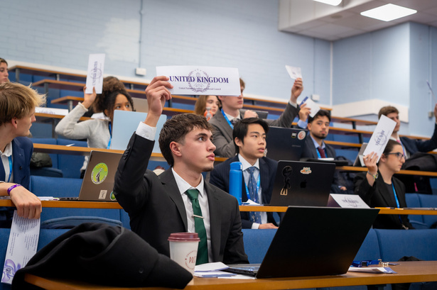 Delegates in committee with the United Kingdom placard raised